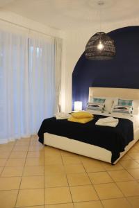 ein Schlafzimmer mit einem großen Bett mit blauer Wand in der Unterkunft Lemon Suite in Neapel