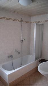 a bathroom with a bath tub and a sink at Ciasa Rosada in San Vigilio Di Marebbe