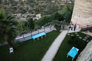 two people standing on top of a lawn with blue tables at Chibao in Ragusa