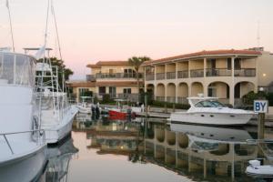 a marina with boats docked in front of a building at Inn at Camachee Harbor View 11 in Saint Augustine