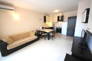 a living room with a couch and a table at Menada Horyzont Apartments in Sozopol