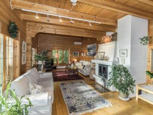 a living room with white furniture and a fireplace at Holiday Home Koivuranta by Interhome in Kylmälä