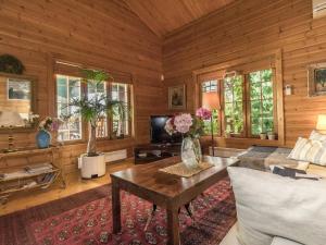a living room with a couch and a table at Holiday Home Koivuranta by Interhome in Kylmälä