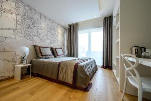 Postel nebo postele na pokoji v ubytování Quarto Novo Suite