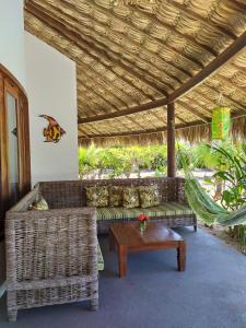 a living room with two couches and a table at Refugios Parajuru - Villa Alegre in Parajuru +44 photos