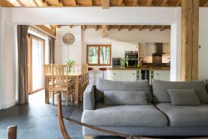 a living room and kitchen with a couch and a table at Chalet Marmotte M1 Penthouse for 8 in Morzine