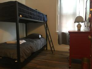 a bedroom with a bunk bed and a desk at Hamtramck Hostel in Detroit