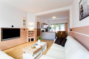 sala de estar con sofá blanco y mesa en Neanderappartement, en Mettmann