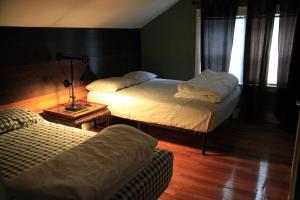 a bedroom with two beds and a lamp on a table at Charming Home Near Ski Areas in Rumford