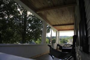 a porch with two chairs and a view of the mountains at Charming Home Near Ski Areas in Rumford