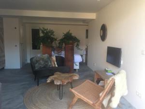 a living room with a couch and a table at Luxury Beach Studio Zandvoort in Zandvoort