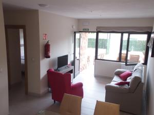 een woonkamer met 2 banken en een televisie bij Apartamentos Borizu Playa in Barro de Llanes