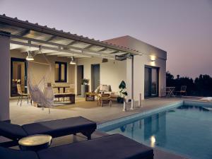 a house with a swimming pool and a patio at Thea lux natur villa in Koríthion
