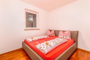 a bed with two pillows on it in a room at Apartment M&M Klimno in Klimno