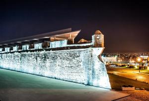 a building that is lit up at night at Pestana Cidadela Cascais - Pousada & Art District in Cascais