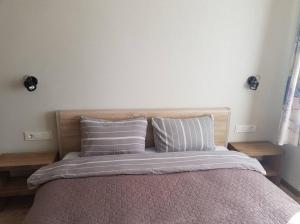ein Schlafzimmer mit einem Bett mit zwei Kissen in der Unterkunft Apartamentai Vilniaus Street II in Šiauliai