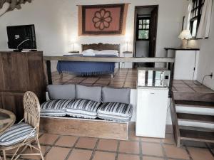 a living room with a couch and a bed at Pousada da Lagoinha in Florianópolis