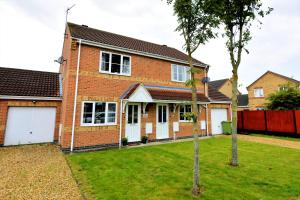 a red brick house with a green yard at Hawthorn House, Lincoln in Lincoln