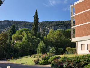 a building with a view of trees and mountains at Casa Alice Garda in Garda