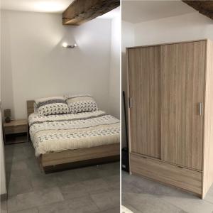 - une chambre avec un lit et une armoire en bois dans l'établissement Appartement spacieux, chaleureux 39 m², à Lagnieu