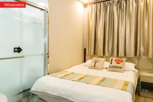 a small bedroom with a bed and a window at Bufan International Hostel in Shanghai