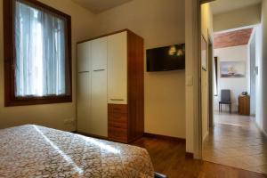 a bedroom with a bed and a dresser and a window at Residence San Miguel (6) in Vicenza
