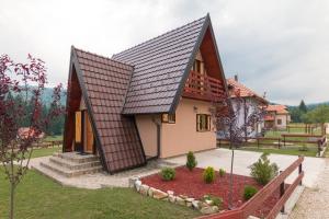 a small house with a brown roof at Mountain house Popović Tara in Bajina Bašta