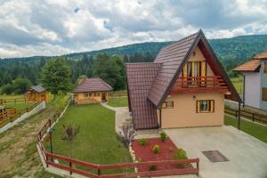 a house with a roof that has a yard at Mountain house Popović Tara in Bajina Bašta