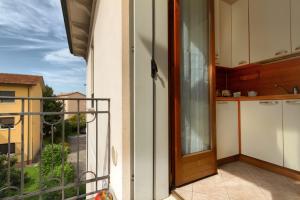 a balcony with a door and a view of a kitchen at Residence San Miguel (6) in Vicenza