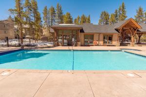 a swimming pool in front of a house at Columbine 206 in Breckenridge