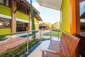 a balcony with a bench on a building at Vila Miola Hotel in Porto Seguro