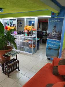 a store with a counter with flowers in it at hotel kasa kamelot 2 in Quetzaltenango
