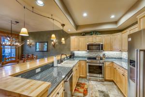 a kitchen with wooden cabinets and stainless steel appliances at Corral at Breckenridge in Breckenridge