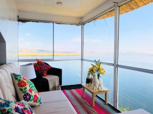 a living room with a view of the water at QHAPAQ Lago Titicaca - Perú in Puno