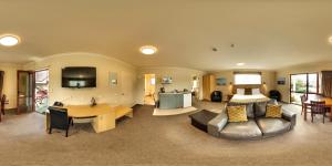 a living room with a couch and a table at 555 Motel Dunedin in Dunedin