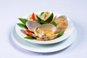 a bowl of oysters on a white plate at Hon Rom Central Beach Resort in Mui Ne