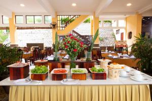 a buffet of food on a table in a restaurant at Hon Rom Central Beach Resort in Mui Ne