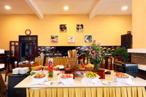 a table with food on it in a restaurant at Hon Rom Central Beach Resort in Mui Ne