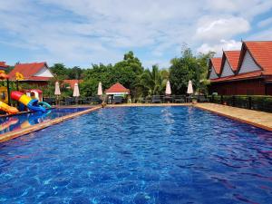 a pool at a resort with a water slide at Phum Khmer Resort in Banlung