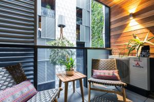a balcony with two chairs and a table at Boutique Abode 313 in Melbourne