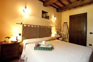 a bedroom with a bed with a tray with flowers on it at Agriturismo Ripaiani in Marsciano