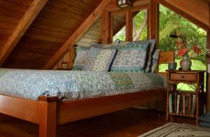 a bed in a room with a window at Volcano Rainforest Retreat in Volcano