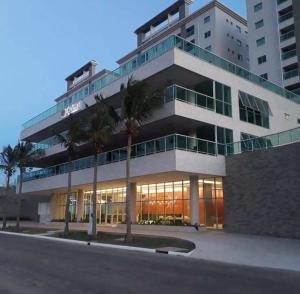 a large building with palm trees in front of it at SALINAS PARK RESORT in Salinópolis