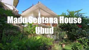 a sign that says madu santa ana housewind at Madu Sentana House in Ubud