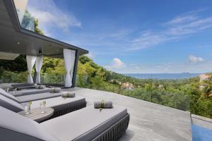 an outdoor patio with a view of the mountains at KW VILLA in Ban Bang Po
