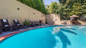 a swimming pool with chaise lounge chairs at Best Western Hollywood Plaza Inn Hotel - Hollywood Walk of Fame LA in Los Angeles