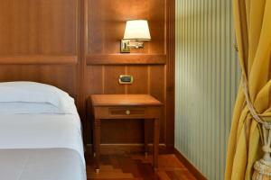 A bed or beds in a room at Best Western Hotel Ferrari
