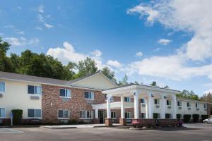 a large brick building with a whiteovation at AmericInn by Wyndham Petoskey in Petoskey