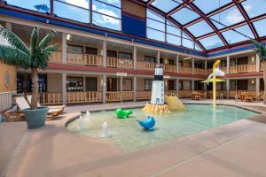 a building with a pool with a lighthouse in the water at AmericInn by Wyndham La Crosse Riverfront Conference Center in La Crosse +59 photos