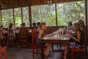 a group of people sitting at a table in a restaurant at Tambopata River in Puerto Maldonado
